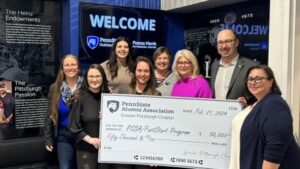 Pittsburgh Alumni Association members + Dana Harris + Justin Aglio posing with big check