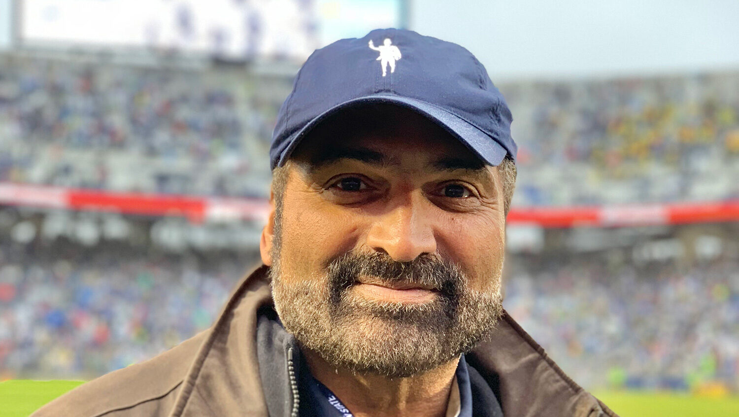 Franco Harris on the sidelines at a football game.