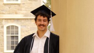 Luke Babik wearing his graduation cap and gown