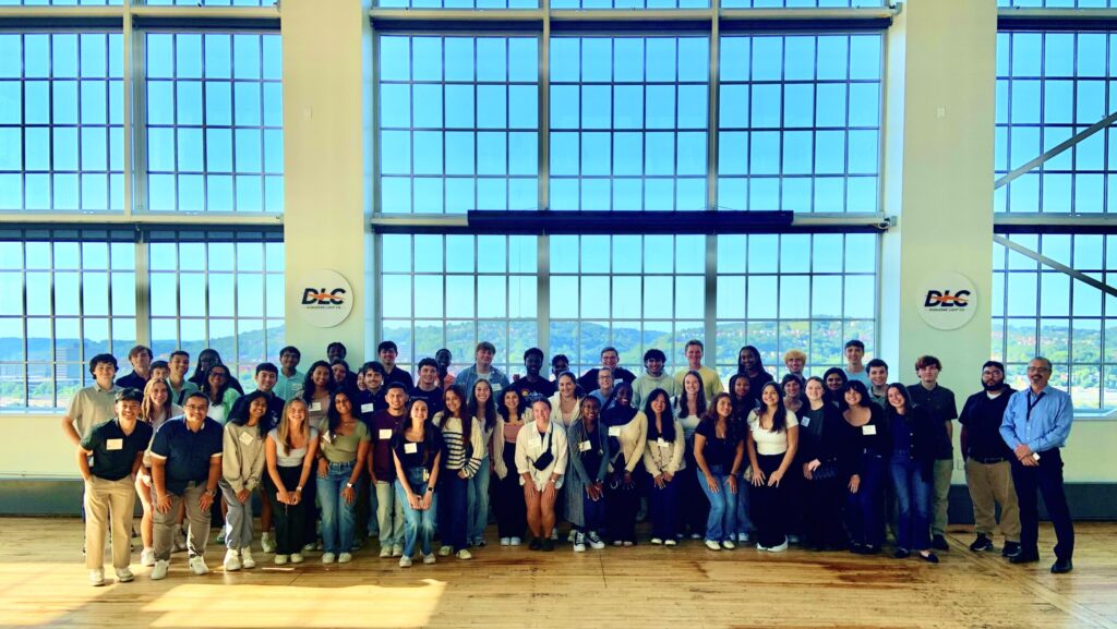 big group of Penn State students posing in big room 