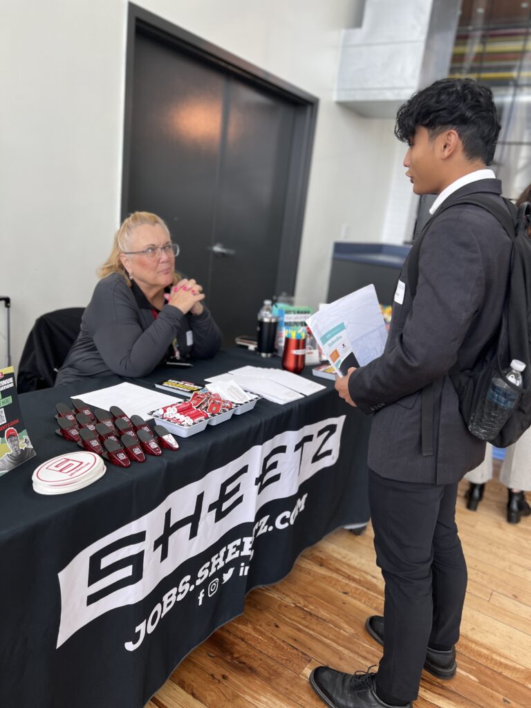 Sheetz table representative talking to student