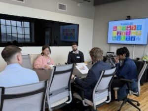 students and instructor at conference table