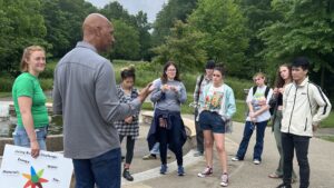 A group of students have a discussion outside at Frick Environmental Center