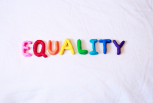 The word "equality" spelled out in letters made from multi-colored clay