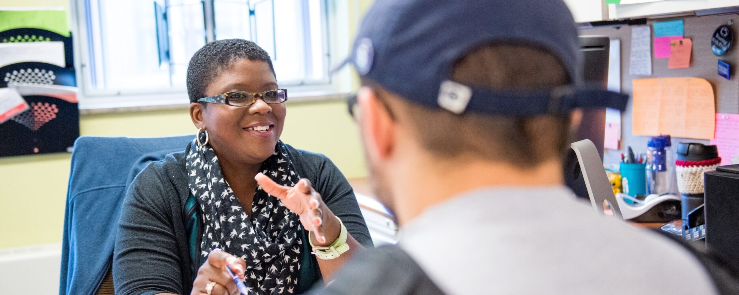 Faculty member speaking with a student in her office