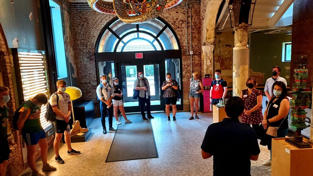 Instructor with a group of students inside a high performance building lobby