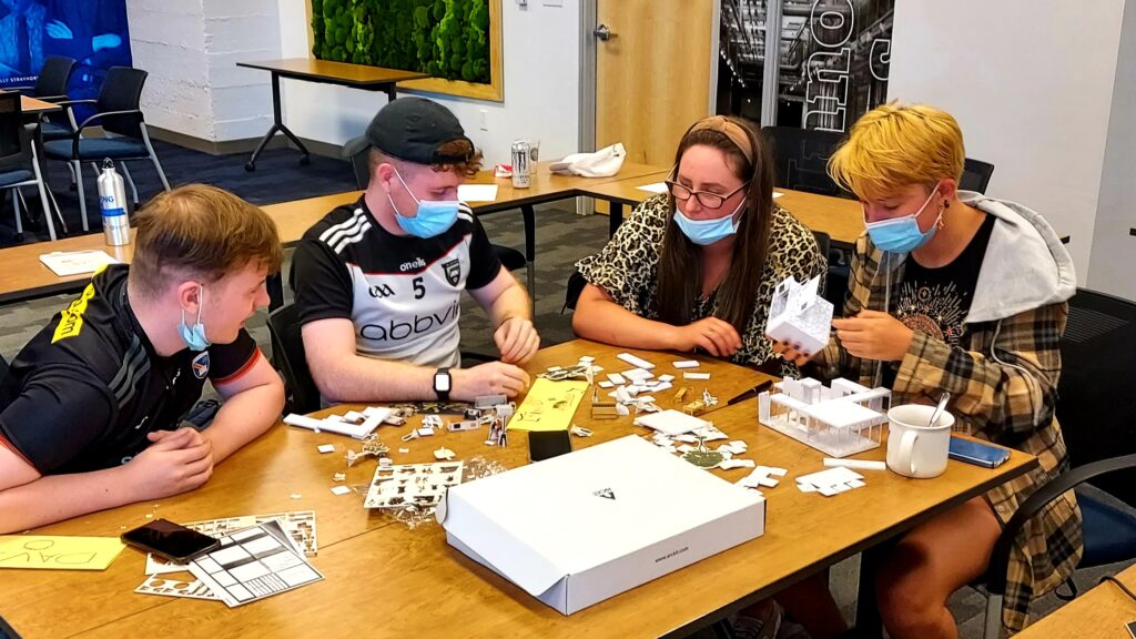 Students sitting around a table working on a project