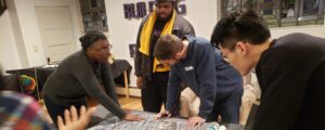 Students looking at community plans on a desk